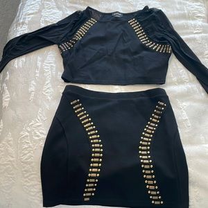Bebe 2 piece skirt set w long sleeve top. Size large in black with gold accent